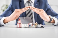 hands over top of a model of a home